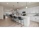 Open kitchen features white cabinets, quartz countertops, pendant lighting and stainless steel appliances at 130 Big Oak Ln, Statesville, NC 28625