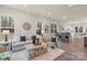 Inviting living room with many windows, hardwood floors, and a view into the dining area at 130 Big Oak Ln, Statesville, NC 28625