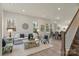 Bright living room with hardwood floors, a modern sofa, and a staircase at 130 Big Oak Ln, Statesville, NC 28625