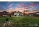 Large, fenced backyard offering ample green space, a fire pit, and a charming home exterior at 1411 Congress St, Gastonia, NC 28054