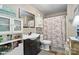 Updated bathroom with a vanity, toilet, decorative mirror, and shower-tub combination at 1411 Congress St, Gastonia, NC 28054