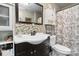 Stylish bathroom featuring a modern vanity, decorative mirror, and updated shower-tub combo at 1411 Congress St, Gastonia, NC 28054