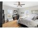 Bright bedroom with hardwood floors, windows, ceiling fan, and large closet space at 1411 Congress St, Gastonia, NC 28054