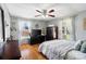 Comfortable bedroom featuring wood floors, natural light, ceiling fan, and modern decor at 1411 Congress St, Gastonia, NC 28054