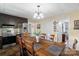 Open dining area with a wooden table, stainless steel refrigerator, and view into other rooms at 1411 Congress St, Gastonia, NC 28054