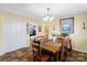 Bright dining room showcases a wood table set for six, with views to the bedroom at 1411 Congress St, Gastonia, NC 28054