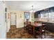Inviting dining area featuring a chandelier, wood table, and adjacent kitchen with dark cabinets at 1411 Congress St, Gastonia, NC 28054