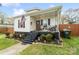 This charming home features a cozy porch and well-maintained landscaping at 1411 Congress St, Gastonia, NC 28054