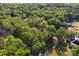 Aerial view of a home nestled among mature trees, showcasing the large, private lot at 1500 Griffith Rd, Monroe, NC 28112