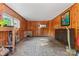 Unfinished basement space featuring wood paneling, a utility sink, and open flooring at 1500 Griffith Rd, Monroe, NC 28112