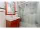 Retro bathroom with a wood vanity and sink alongside a frosted glass shower enclosure at 1500 Griffith Rd, Monroe, NC 28112