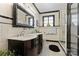 Stylish bathroom showcasing dual sinks, a glass-enclosed shower, and classic black and white tile for a timeless appeal at 1500 Griffith Rd, Monroe, NC 28112