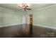 Spacious bedroom with hardwood floors, open closet space, and a neutral color palette for a calming atmosphere at 1500 Griffith Rd, Monroe, NC 28112