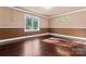 Empty bedroom with hardwood floors, natural light, and neutral tones, offering a blank canvas for personal design at 1500 Griffith Rd, Monroe, NC 28112