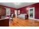 Large bedroom includes hardwood floors, furniture, a large window and ensuite bathroom at 1500 Griffith Rd, Monroe, NC 28112