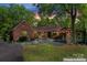 The home features a cozy outdoor patio with lighting and rustic details, perfect for evening relaxation at 1500 Griffith Rd, Monroe, NC 28112