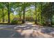 Scenic view of a brick home surrounded by mature trees and a private driveway at 1500 Griffith Rd, Monroe, NC 28112