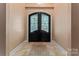 Welcoming foyer with tiled floor and decorative glass double doors adding a touch of elegance at 1500 Griffith Rd, Monroe, NC 28112