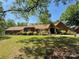 Charming red brick home with a well-manicured lawn, mature trees, and a welcoming entrance at 1500 Griffith Rd, Monroe, NC 28112