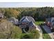 Aerial view of a home with a manicured lawn, mature trees and a long driveway at 15009 Lisha Ln, Charlotte, NC 28277