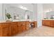 Spacious bathroom with wood cabinetry, a large mirror, and tile flooring at 15009 Lisha Ln, Charlotte, NC 28277
