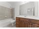 Tiled bathroom with a single sink vanity and tub with shower at 15009 Lisha Ln, Charlotte, NC 28277