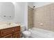 Cozy bathroom featuring tile flooring, a bathtub, and a sink vanity with wooden cabinets at 15009 Lisha Ln, Charlotte, NC 28277