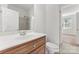 Bathroom featuring a white vanity with chrome fixtures and a shower at 15009 Lisha Ln, Charlotte, NC 28277
