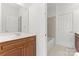 Well-lit bathroom with a single vanity, tile flooring, and tub with shower at 15009 Lisha Ln, Charlotte, NC 28277