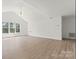 Large, bright bedroom featuring a vaulted ceiling, fan, and light hardwood floors at 15009 Lisha Ln, Charlotte, NC 28277
