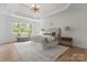 Luxurious bedroom with tray ceiling, large windows, and stylish decor, offering a serene retreat at 15009 Lisha Ln, Charlotte, NC 28277