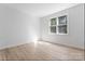 Bright bedroom features hardwood floors, and a large window bringing in natural light at 15009 Lisha Ln, Charlotte, NC 28277