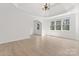 Spacious room with tray ceiling, chandelier, hardwood floors and many windows at 15009 Lisha Ln, Charlotte, NC 28277
