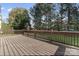 A wooden deck with railings overlooks the backyard and surrounding landscape at 15009 Lisha Ln, Charlotte, NC 28277