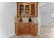 Elegant dining area with wood cabinets, wine rack, granite countertop, and tiled backsplash at 15009 Lisha Ln, Charlotte, NC 28277