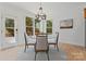 Breakfast nook with hardwood floors, chandelier, table, chairs, and access to the outdoors at 15009 Lisha Ln, Charlotte, NC 28277
