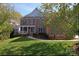 Charming two-story red brick home with a well-manicured lawn and a welcoming front porch at 15009 Lisha Ln, Charlotte, NC 28277