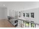 Open hallway featuring hardwood floors, decorative columns, and railing at 15009 Lisha Ln, Charlotte, NC 28277