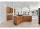 Gourmet kitchen with granite counters, wood cabinets, stainless cooktop and tiled backsplash at 15009 Lisha Ln, Charlotte, NC 28277