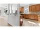 Bright kitchen with granite counters, wood cabinetry and stainless appliances overlooking breakfast bar at 15009 Lisha Ln, Charlotte, NC 28277