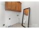 Laundry room featuring cabinet and tile floor at 15009 Lisha Ln, Charlotte, NC 28277