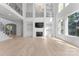 Open-concept living room with a fireplace, built-in shelves, and soaring ceilings at 15009 Lisha Ln, Charlotte, NC 28277