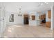 Open-concept living space with hardwood floors, chandelier, and view into the kitchen area at 15009 Lisha Ln, Charlotte, NC 28277