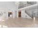 Bright and airy living room with hardwood floors, high ceilings, and staircase with metal spindles at 15009 Lisha Ln, Charlotte, NC 28277