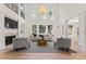 Spacious living room with high ceilings, fireplace, large windows and modern furniture at 15009 Lisha Ln, Charlotte, NC 28277