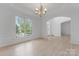 Elegant living room with a chandelier, large windows, and hardwood floors at 15009 Lisha Ln, Charlotte, NC 28277