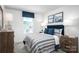 Cozy bedroom with coordinated blue and white bedding, matching nightstands and window with natural light at 154 Jameson Park Dr # 3, Troutman, NC 28166