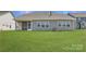 View of the backyard featuring a screened porch and well-maintained lawn at 1557 Croydon St, Indian Land, SC 29707