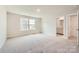 Bright bedroom with large window, neutral paint, carpet flooring and an ensuite bath at 1557 Croydon St, Indian Land, SC 29707