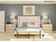 This bedroom has an ensuite bathroom, pale-blue walls, and lovely decorative pillows at 1557 Croydon St, Indian Land, SC 29707